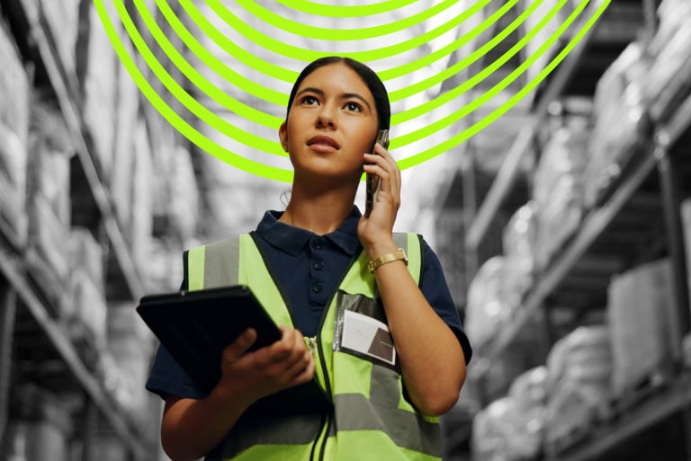 image of person using phone in a warehouse to illustrate call tracking