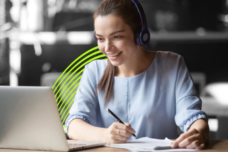 women at computer learning with headphones on