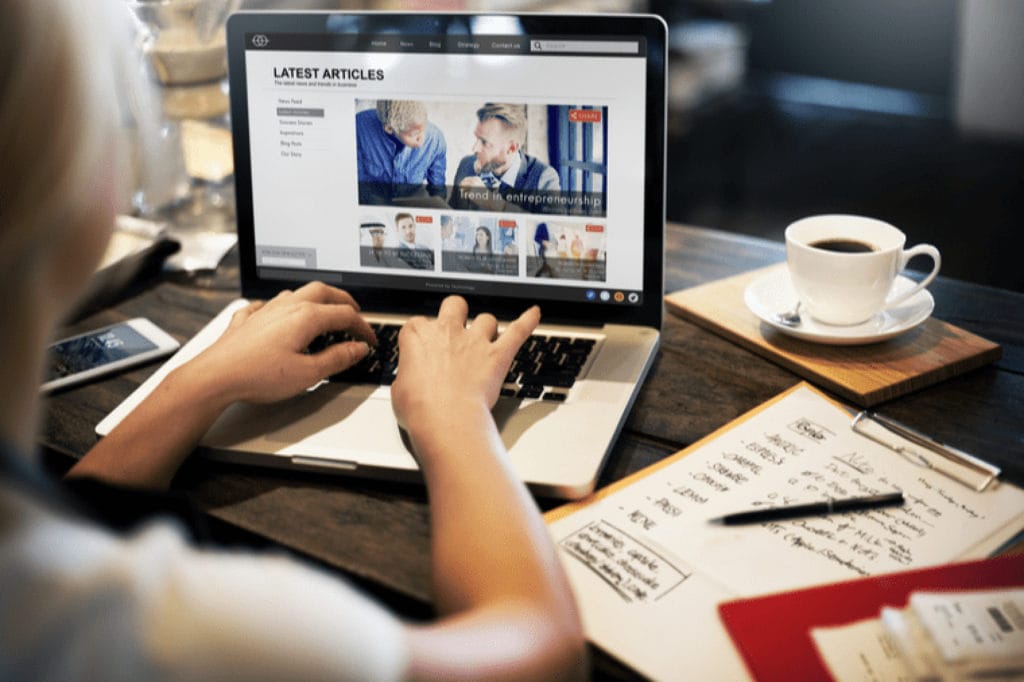 woman updating a website on her laptop